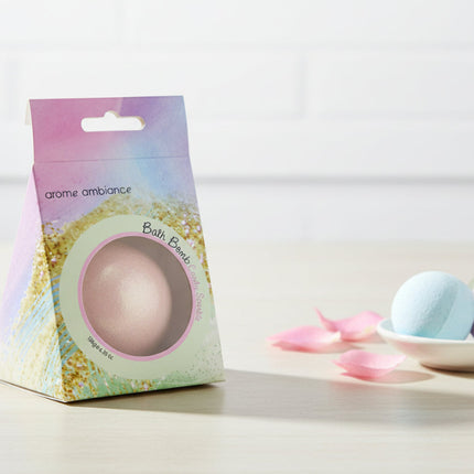 Bath bomb packaging with a pink bath bomb and colorful packaging on a white background