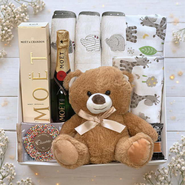 Collection of gifts including a teddy bear, Byron bay fudge, Moet with teddy bear from The Baby Gift Company.