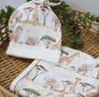 Baby hat and blanket set with safari animal print on a woven basket
