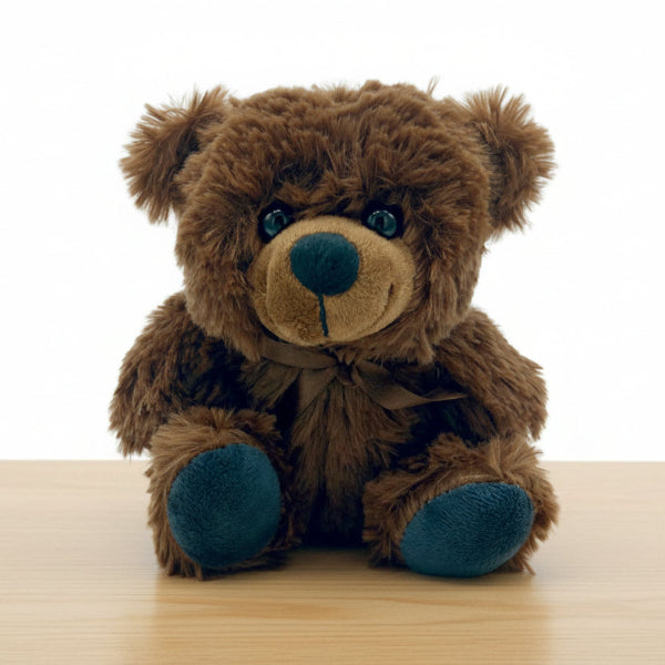 brown plush teddy bear on table