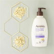 Aveeno Stress Relief Moisturising Lotion bottle with hexagonal frames containing oatmeal on a light gray background