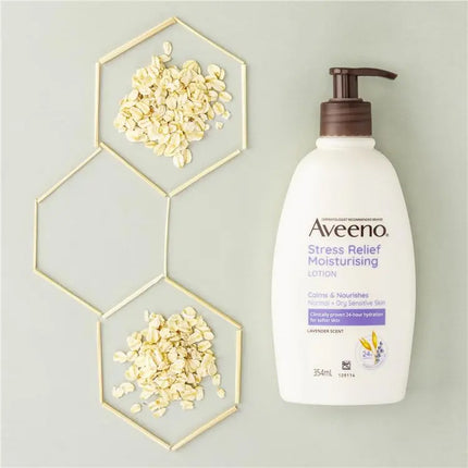 Aveeno Stress Relief Moisturising Lotion bottle with hexagonal frames containing oatmeal on a light gray background