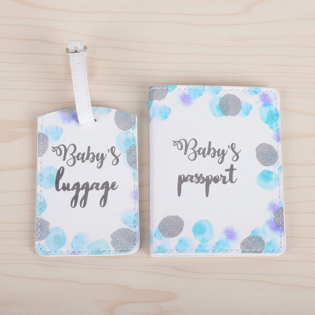 Baby-themed luggage tag and passport cover with polka dot design on a table background