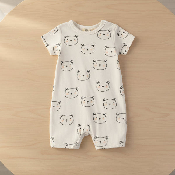 Baby romper with bear pattern on a table background