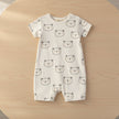 Baby romper with bear pattern on a table background