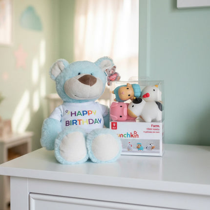 Light blue teddy bear with 'Happy Birthday' shirt and animal bath toys