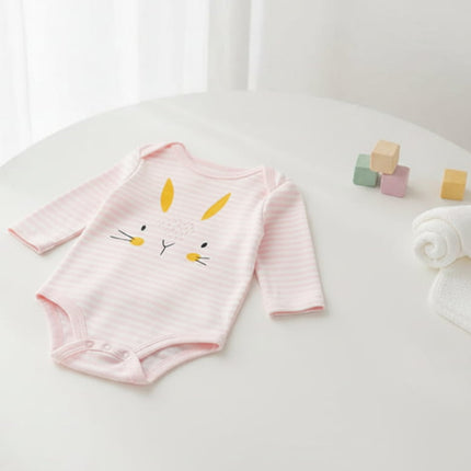 Baby pink and white striped onesie with bunny face on a table