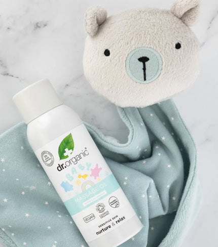 Dr. Organic product with a plush toy on a light blue blanket