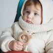 Baby holding Personalised Wooden Teddy Rattle