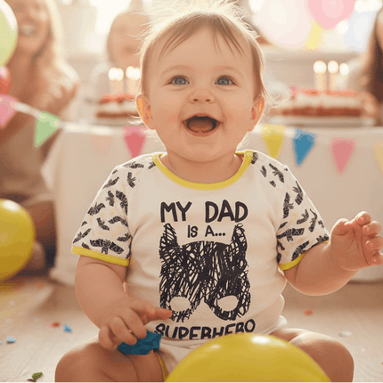 Smiling baby wearing batman top at party