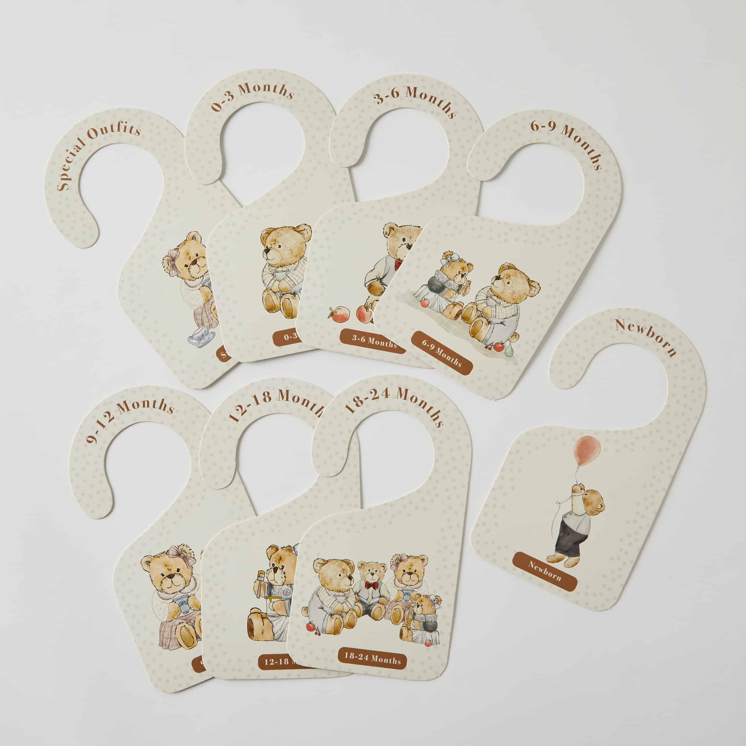 Set of baby growth chart hangers with teddy bear illustrations on a light gray background