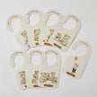 Set of baby growth chart hangers with teddy bear illustrations on a light gray background