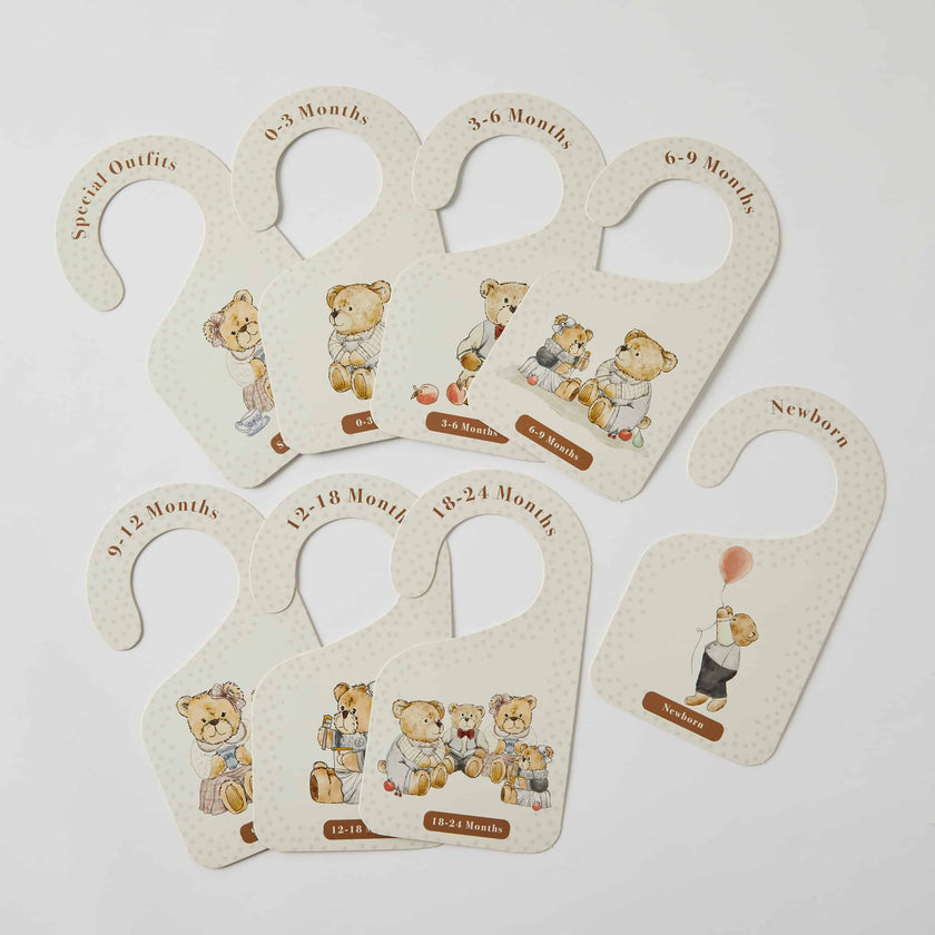 Set of baby growth chart hangers with teddy bear illustrations on a light gray background