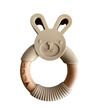 Beige bunny-shaped teething ring with wooden ring on a white background
