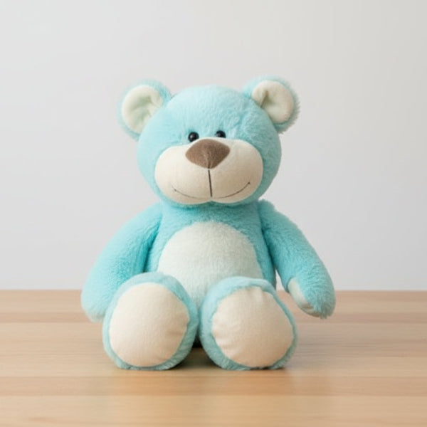 Blue teddy bear with a white muzzle on a table