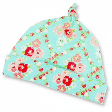 Pretty flower baby hat on white background