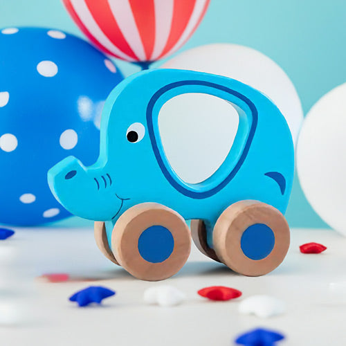 Blue elephant toy with wooden wheels on a light blue background