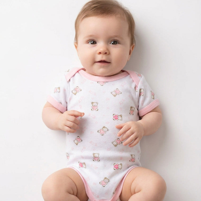 Baby wearing pink and white romper
