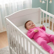 baby weraing Bonds Pink Zip Wondersuit in cot