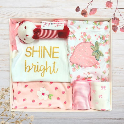 Baby gift set with 'SHINE bright' shirt, floral baby girl clothes , and strawberry pants for baby in a gift box.