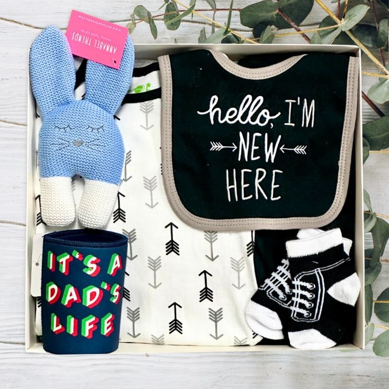 Baby gift set with blue bunny toy, dad stubby, baby bib, and socks in a gift box.