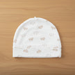 White baby hat with small bear pattern on a table