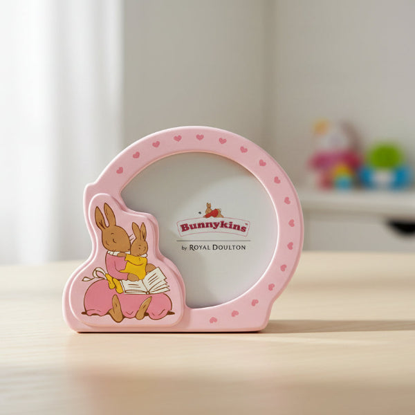 Pink photo frame with a child's picture and Bunnykins design on a table
