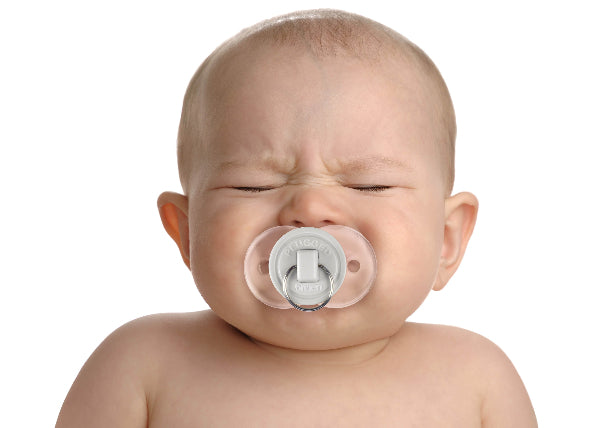 Baby with a pacifier on a white background