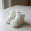 Baby Cable Knitted Booties on a table
