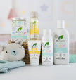 Dr. Organic baby product line including bottles and a toy on a light background