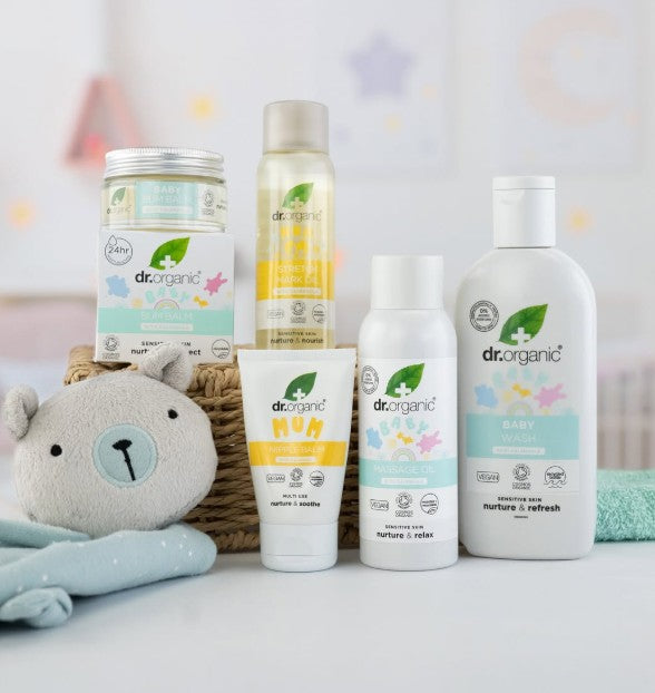 Dr. Organic baby product line including bottles and a toy on a light background