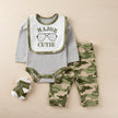 Baby outfit set with gray long-sleeve shirt, green camouflage pants, and matching socks on a beige background.
