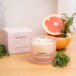 Koch & Co candle with grapefruit and thyme on a wooden surface
