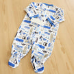 Baby onesie with vehicle pattern on a wood background