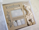 Bamboo by Bubba Blue 3-piece newborn set with a giraffe toy on a light background