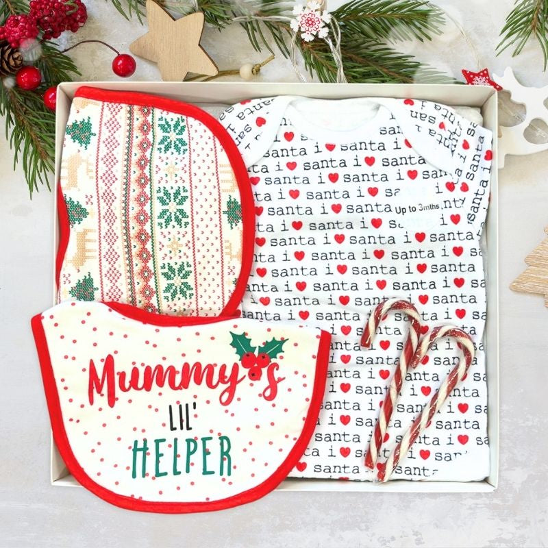 Set of baby bibs with Christmas-themed designs and text in a decorative box.