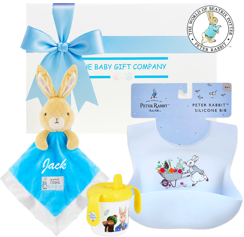 Baby gift set with plush toy, bib, and sippy cup featuring Peter Rabbit design.