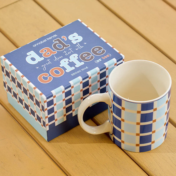 Blue and white checkered mug with matching box on a wooden surface