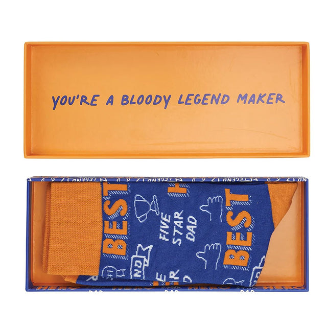 Orange box with blue text and a pair of socks inside, featuring text and graphics.