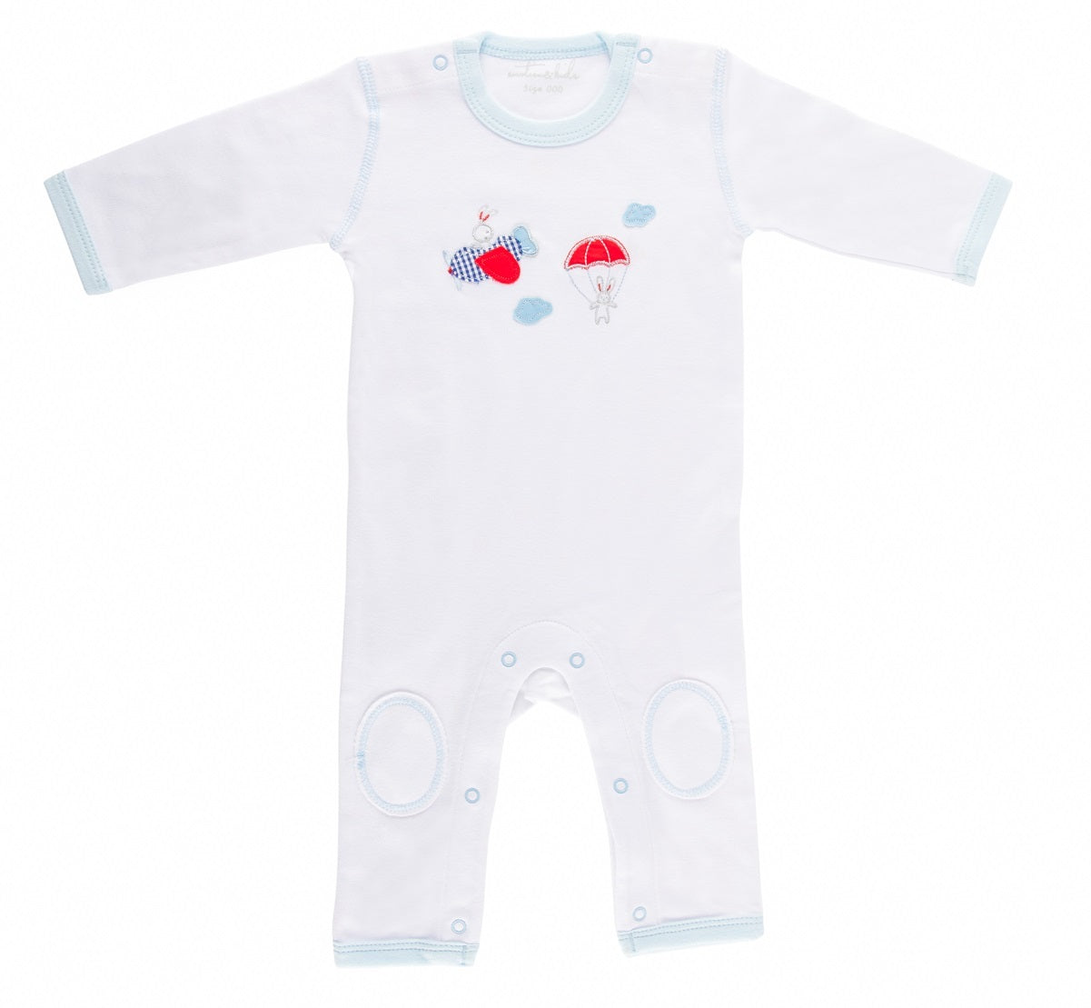 White baby romper with colorful airplane design on a white background