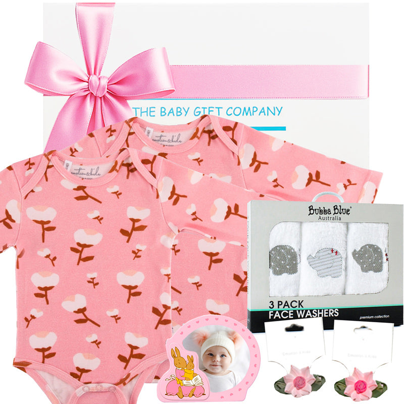 Baby gift set with bibs, burp cloths, and photo frames from The Baby Gift Company.