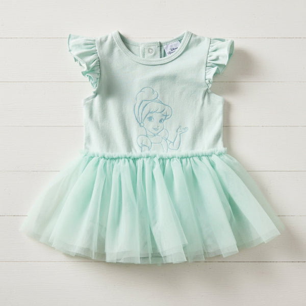 Mint green dress with a character design on a wood background
