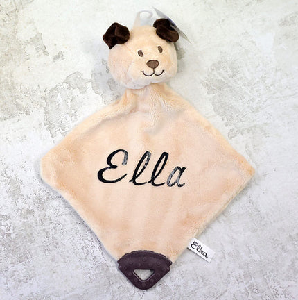 Plush toy with a name 'Ella' on a textured surface