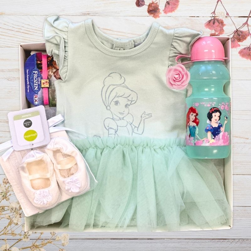 Disney green dress with tulle skirt, water bottle, and toys in gift box on a wooden surface.