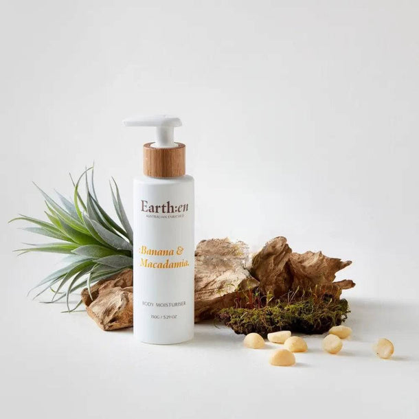 Earth:en Banana & Macadamia body lotion with natural elements on a light background