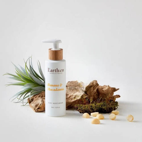 Earth:en Banana & Macadamia body lotion with natural elements on a light background