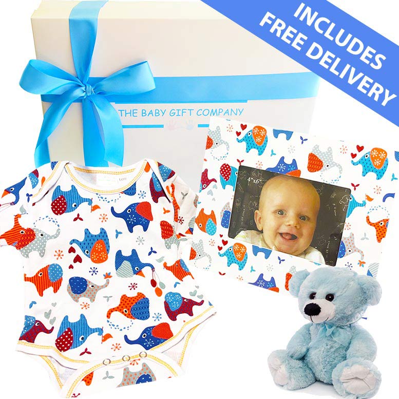 Baby gift set with onesie, photo frame, and teddy bear from The Baby Gift Company.