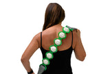 Woman wearing a back massager with green straps and white massage pads on a white background