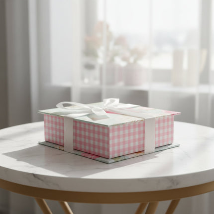 Memo box with floral pattern and pink checkered base on a table
