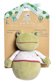 Green plush toy frog with a white bib on a brown card with branding